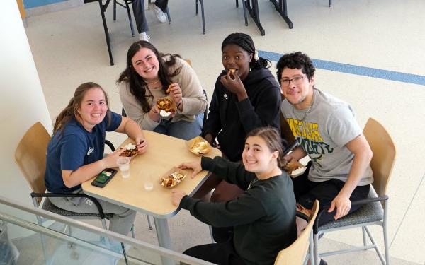 Students from above sitting at table in Hammond eating french fries