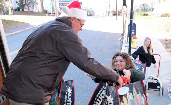 Students help load gifts in the truck for care and share