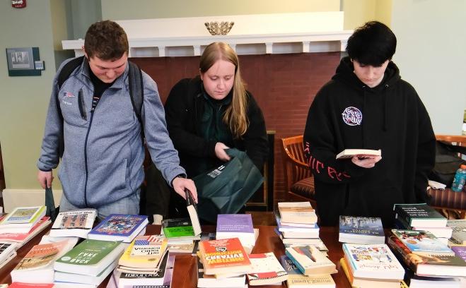 Students looking at books in Miller Hall