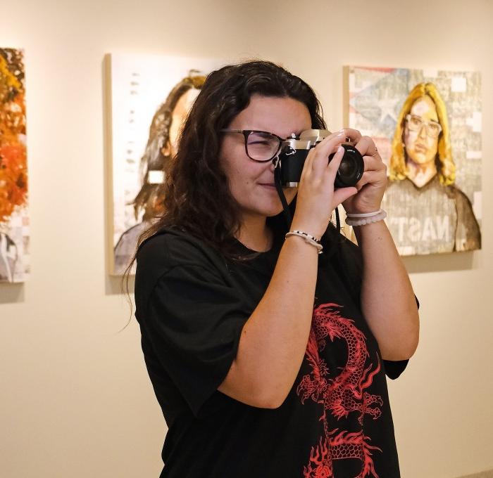 Girl taking photo in the art gallery